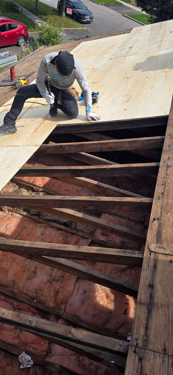 Roofer repairing an open roof deck during construction